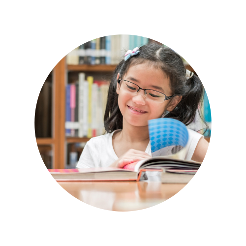 Picture of a student reading a book in the library.
